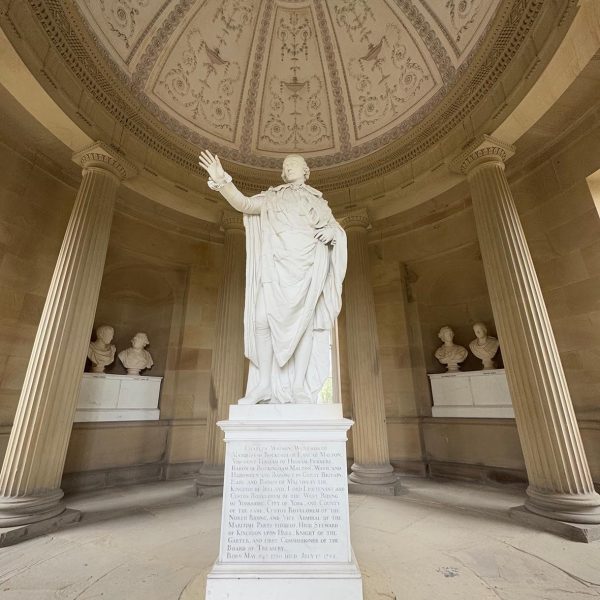 Statue of the 2nd Marquis of Rockingham inside Rockingham Monument with bust of his closest friends in the background.
